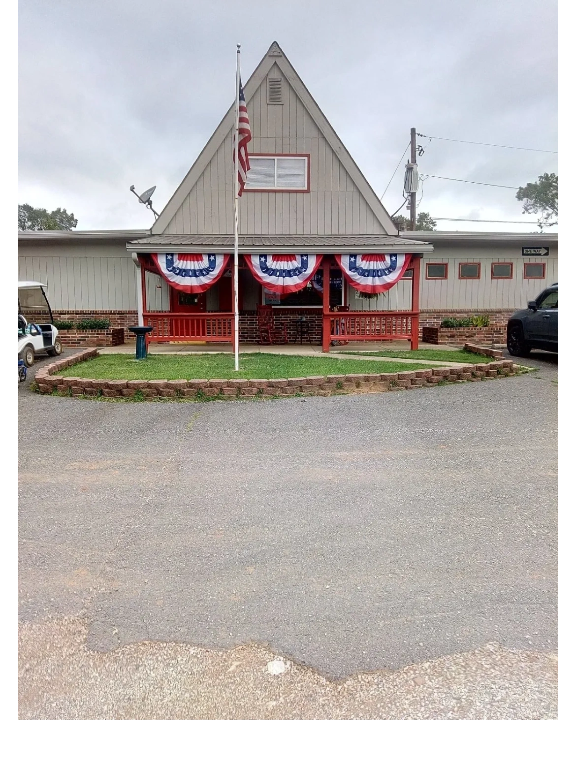 The welcoming front porch and distinctive peaked roof at Caddo Valley RV Park